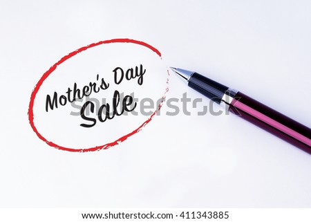 The words Mother's Day Sale written in a red circle with a pen on isolated white background. Concept of love for mother's. 