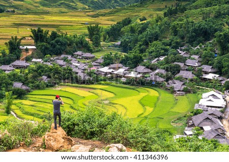 Traveler take picture at Rice fields on terraced of Tu le District, YenBai province, Northwest Vietnam