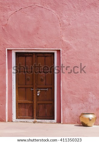 wooden door in a pink wall