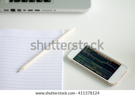 phone and business stock application on work desk