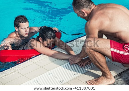 Lifeguards in training - Rescuing victim from public swimming pool