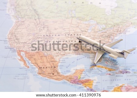 Miniature of a passenger plane flying on the map of United States of America from south east. Conceptual image for tourism and travel Royalty-Free Stock Photo #411390976