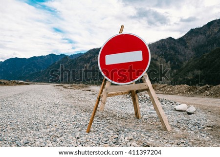 Road sign brick, in the Altai mountains in the spring.