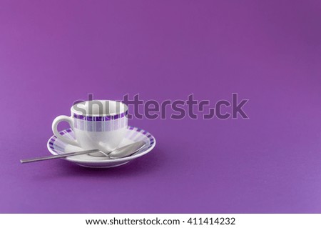 a little cup of espresso coffee on colored background