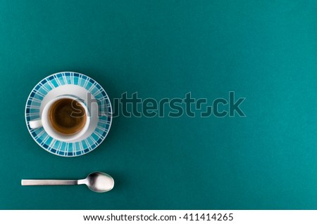 a little cup of espresso coffee on colored background