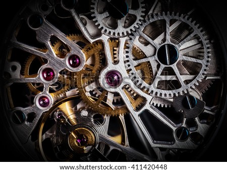 Mechanism, clockwork of a watch with jewels, close-up. Vintage luxury background. Time, work concept. Royalty-Free Stock Photo #411420448