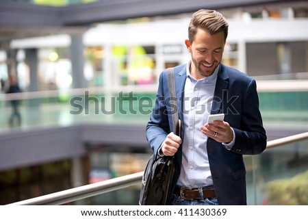 View of a Young attractive business man using smartphone Royalty-Free Stock Photo #411430369