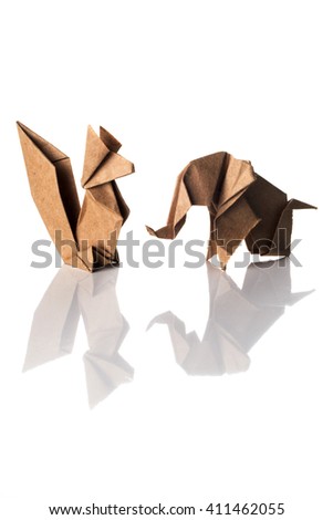 Craft paper origami elephant and squirrel isolated on white background.