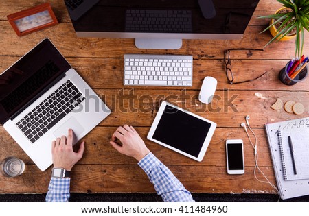Business person working at office desk, wearing smart watch