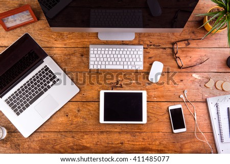 Desk, gadgets and office supplies. Flat lay. Wooden background.