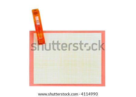 A rectangular piece of orange and yellow paper clipped by an orange peg. The image is isolated on a white background. The paper is blank