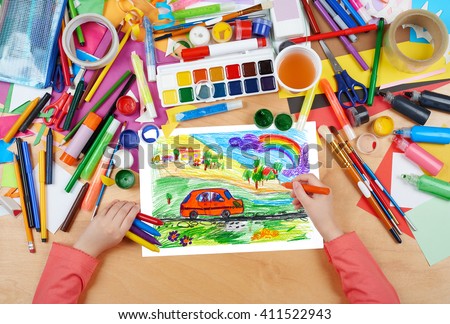 child drawing dog travel in car , top view hands with pencil painting picture on paper, artwork workplace