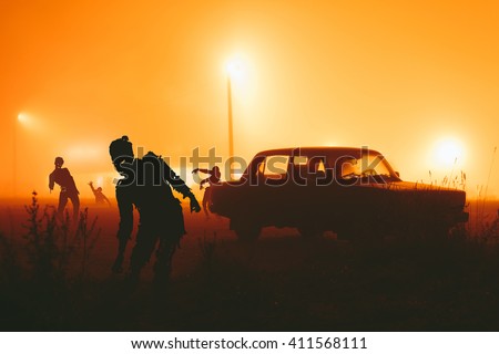 Several zombie on the street at night. Royalty-Free Stock Photo #411568111