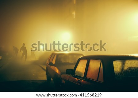 Several zombie on the street at night. Royalty-Free Stock Photo #411568219
