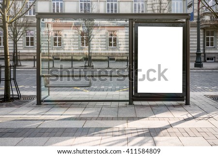 Blank white mockup of bus stop vertical billboard in front of empty street background Royalty-Free Stock Photo #411584809