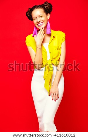 portrait of cheerful fashion hipster girl in casual colorful vivid hipster yellow summer clothes on red background 