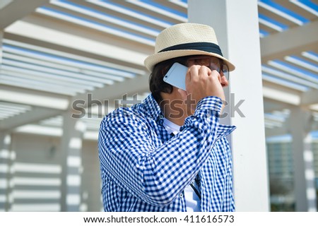 Side view shot of person holding using smartphone on terrace background outdoors
