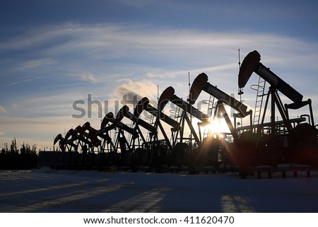 Row of Oil Pump Jacks in the Sunset