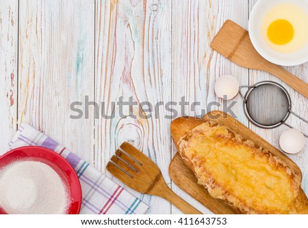 ready to bake buns, bread. On white wooden background lie the ingredients and utensils. place for title