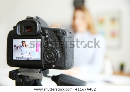 Young female blogger on camera screen Royalty-Free Stock Photo #411674482