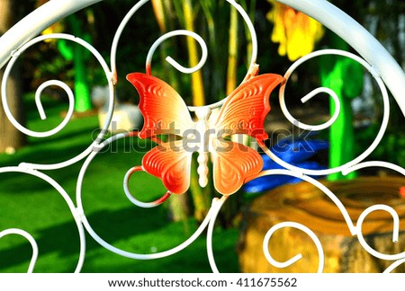 The red butterfly on white curved steel - select focus on butterfly