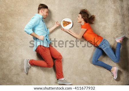 Scene simulation, young couple with pizza Royalty-Free Stock Photo #411677932