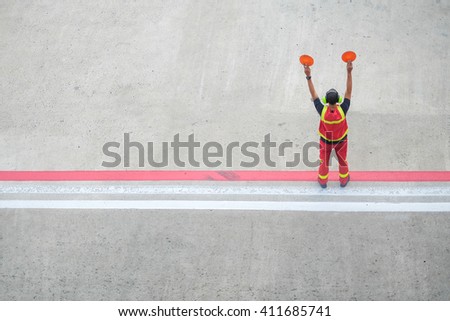 worker holding stop sign