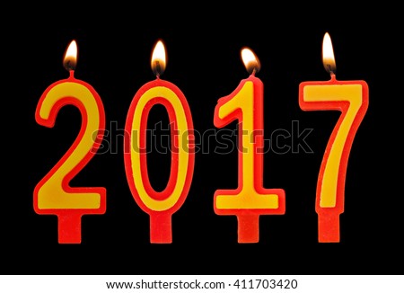 Burning candles on black background, number 2017, new year concept