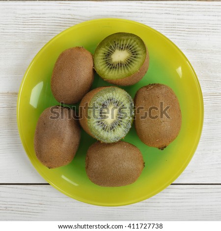 Halves and whole kiwi placed on a plate