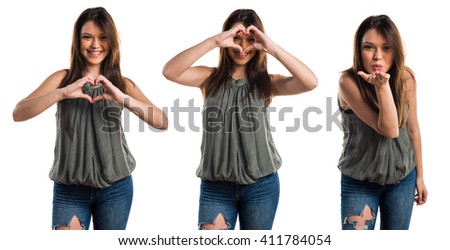 Young girl making a heart with her hands