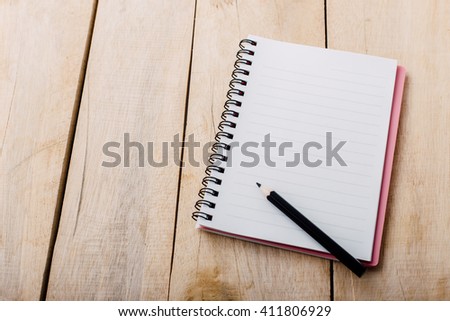 note book on wooden table