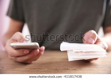 Male hands using calculator apps at the table Royalty-Free Stock Photo #411817438