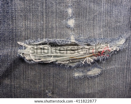 closeup view old denim with fade on blue jeans Heavy Use construction worker 
