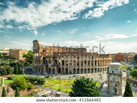 Colosseum or Coliseum, Rome, Italy. Panorama of Rome city center, skyline with Colosseum. Ancient Roman Colisseum is top Roma landmark. Landscape of Rome with Colloseum and blue sky. Travel theme. Royalty-Free Stock Photo #411866485