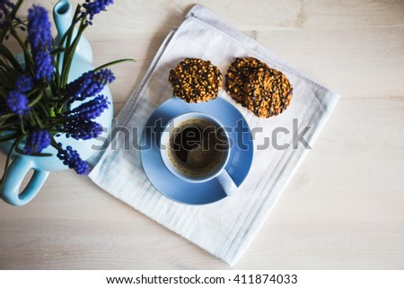 A cup of coffee with flowers and cookies. Vintage