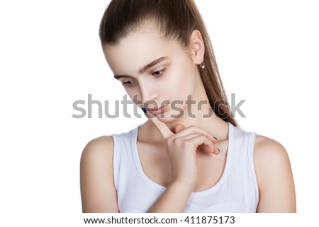 portrait of a pretty teen girl on a white background. Human emotions, sad girl. Isolation on a white background