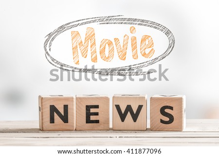 Movie news sign cubes on a table with a sketch