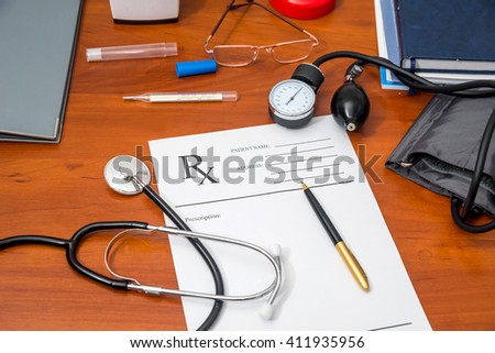 rx prescription with pills, stethoscope, thermometer and pen