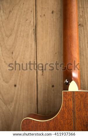 folk guitar, unplugged music instrument with wood background.