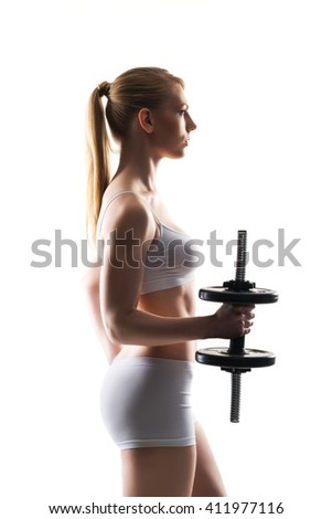 Hot and fit beautiful woman having bicep training with dumbbells on isolated background.
