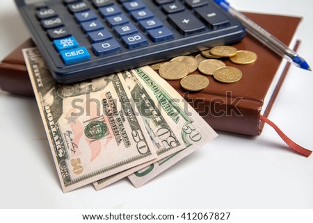 picture a few dollar bills lay under calculator