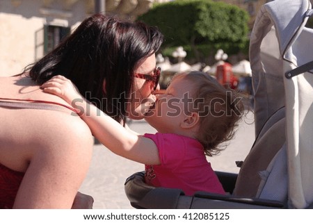 Cute little girl kisses her mommy with love