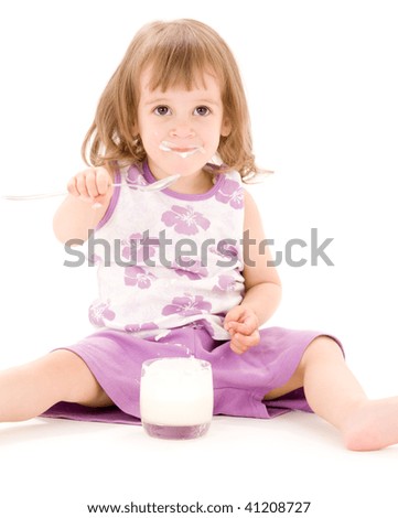 picture of little girl eating yoghurt over white