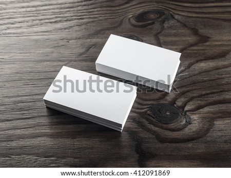 Blank business cards on wooden table. Template for ID. Top view. Stacks of blank business cards on wooden background.