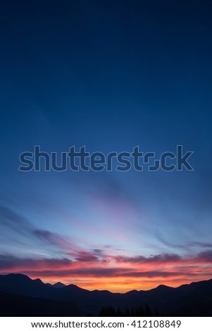 Colorful beautiful sunset over the mountain hills
