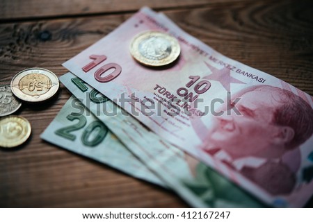 Turkish lira bills and coins on wooden table Royalty-Free Stock Photo #412167247
