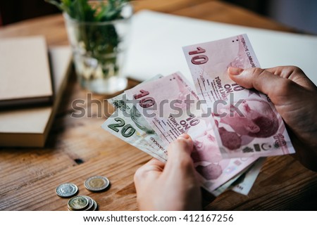 Hands holding turkish lira bills Royalty-Free Stock Photo #412167256