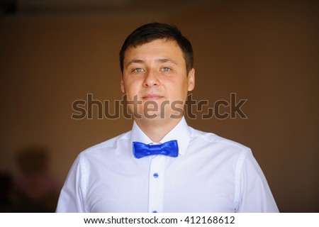groom dressing up in the room