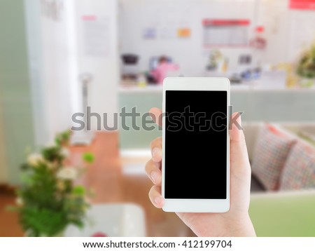 woman use mobile phone and blurred image of beauty clinic