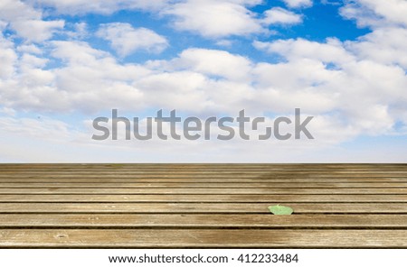Cloudy blue sky and wood floor, background image.